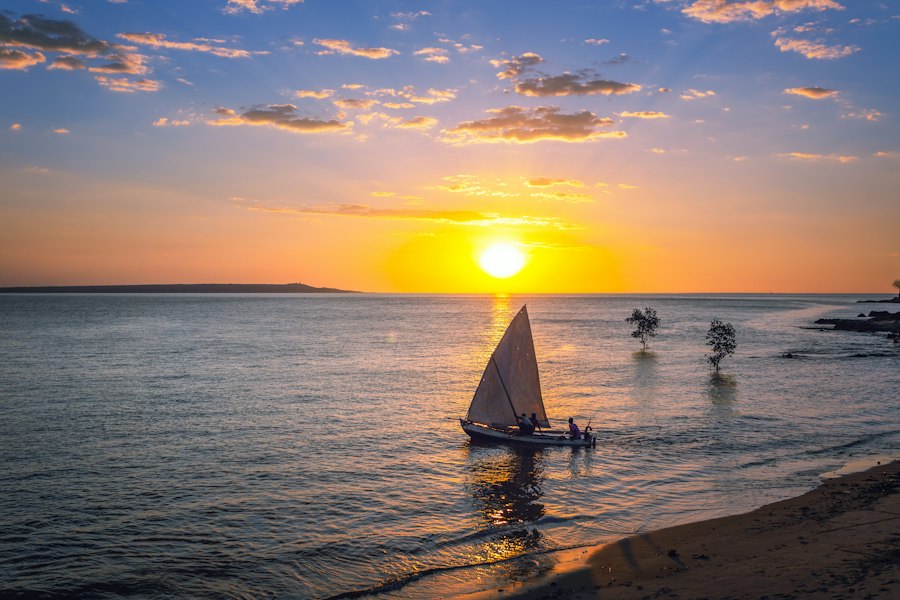 A lateen-sailed dhow on the water at sunset