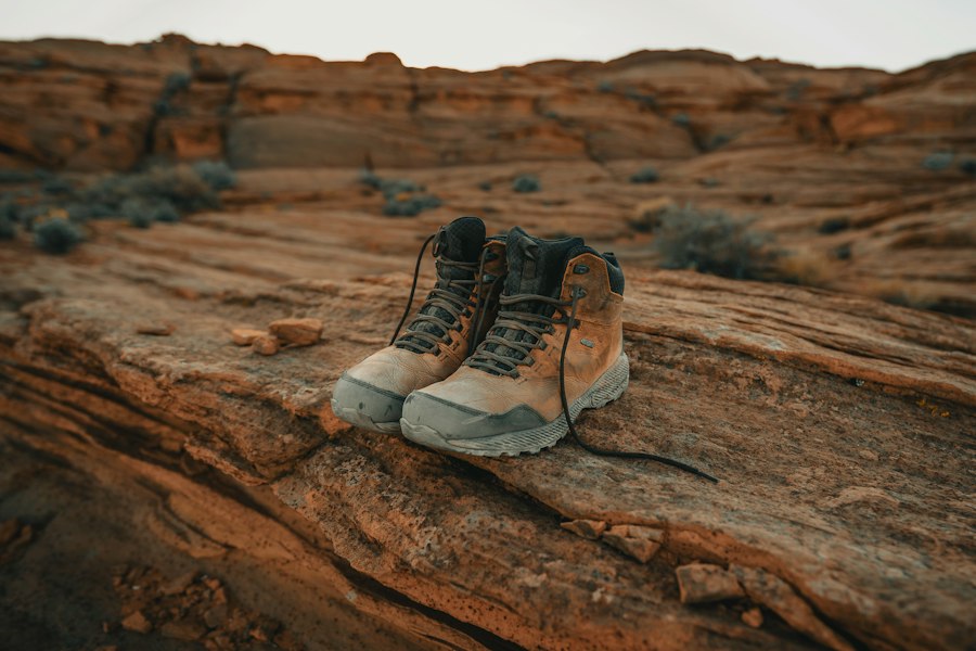Leather hiking boots resting on red rock