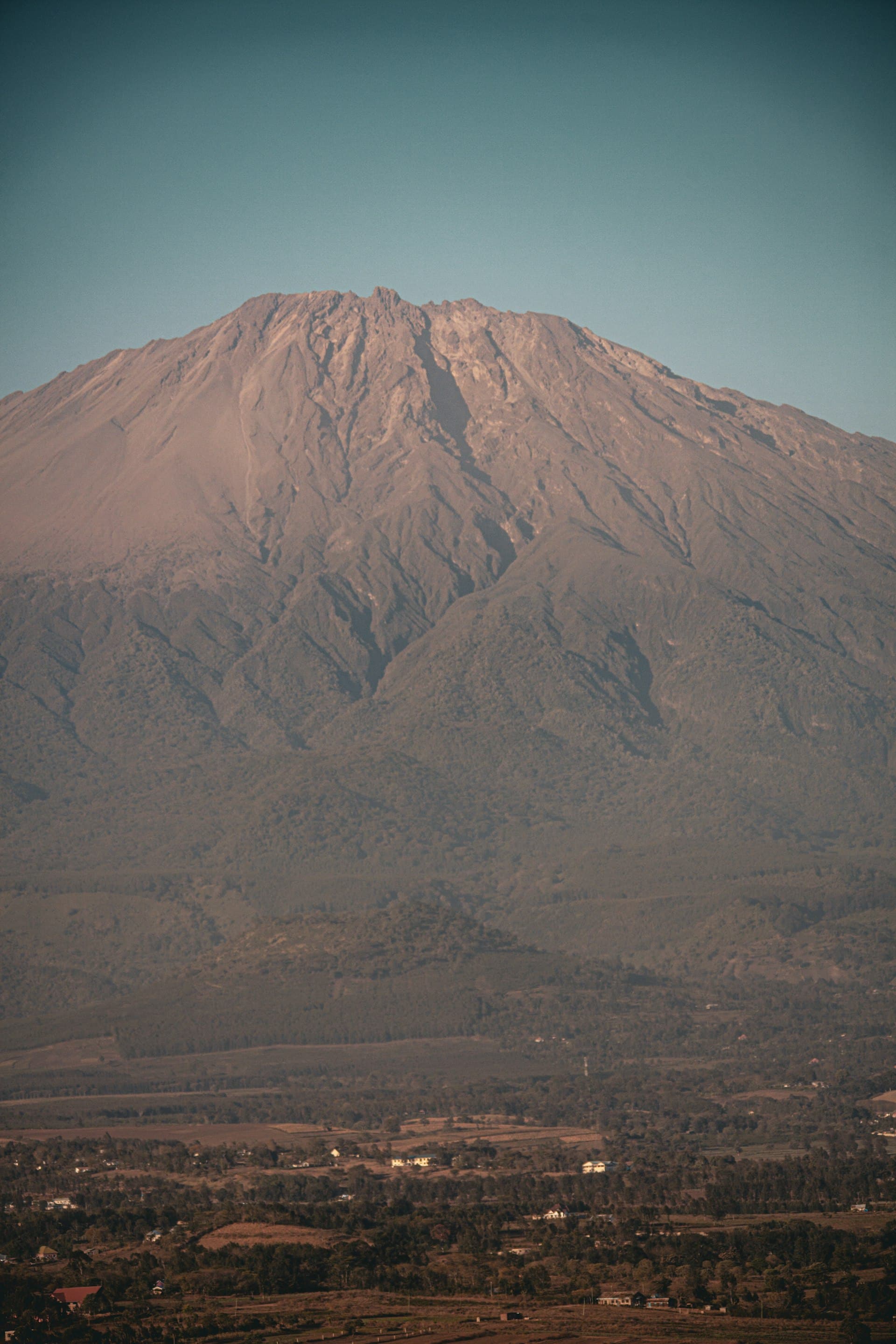The steep, ridged flank of Mount Meru towering above Arusha National Park